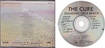Standing on a beach  The singles (issued 1987). Misprint. First Disctronics release. The CD is incorrectly screen-printed with the 13 tracks from the vinyl LP. All other artwork references the 17 tracks that are playable on the disc. - Thanks to damned